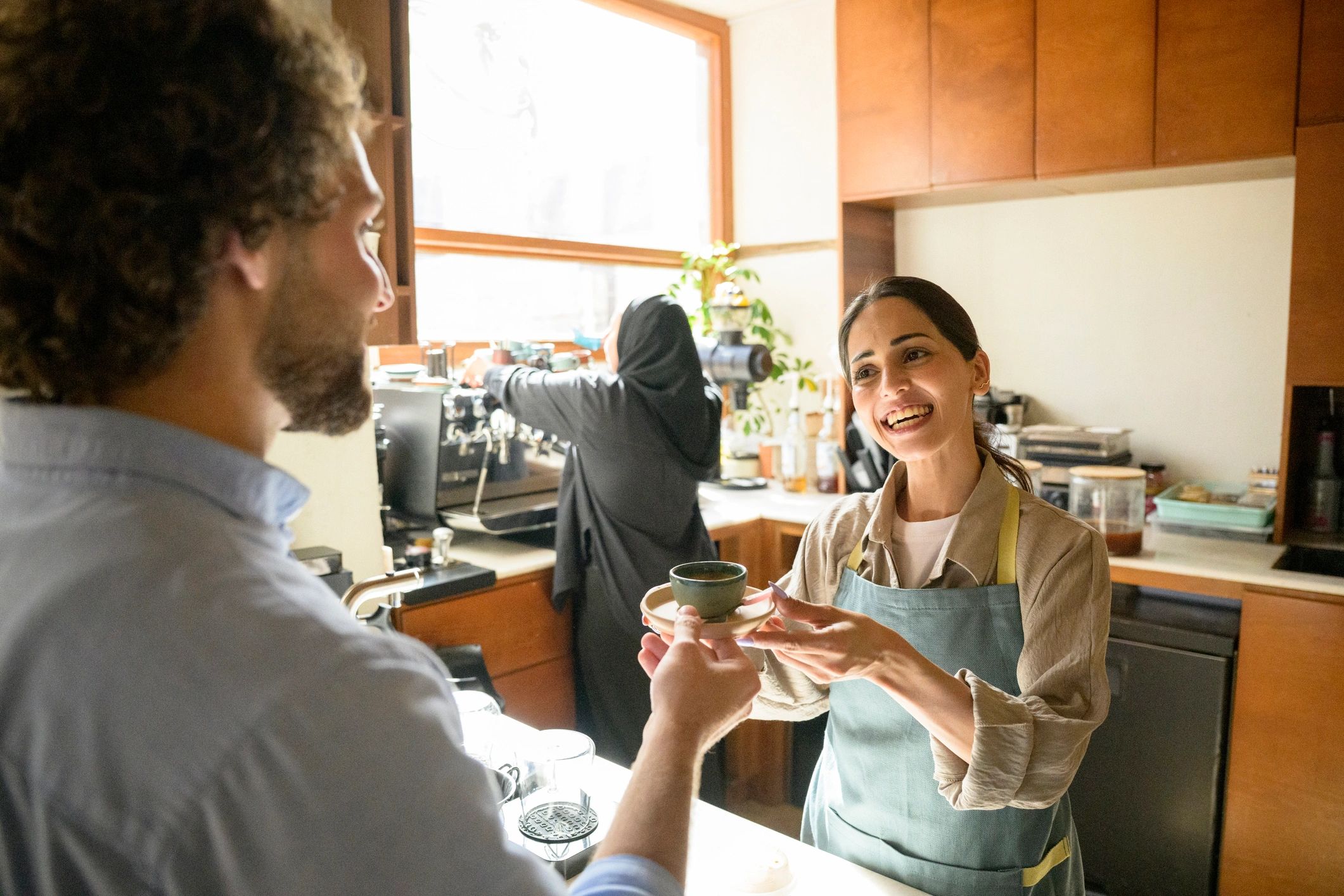 Barista serving coffee to a customer