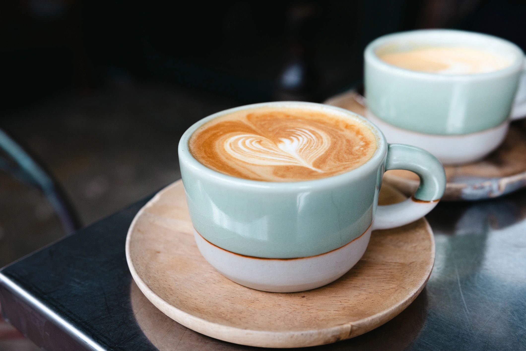 Coffee served in a green mug on a café table