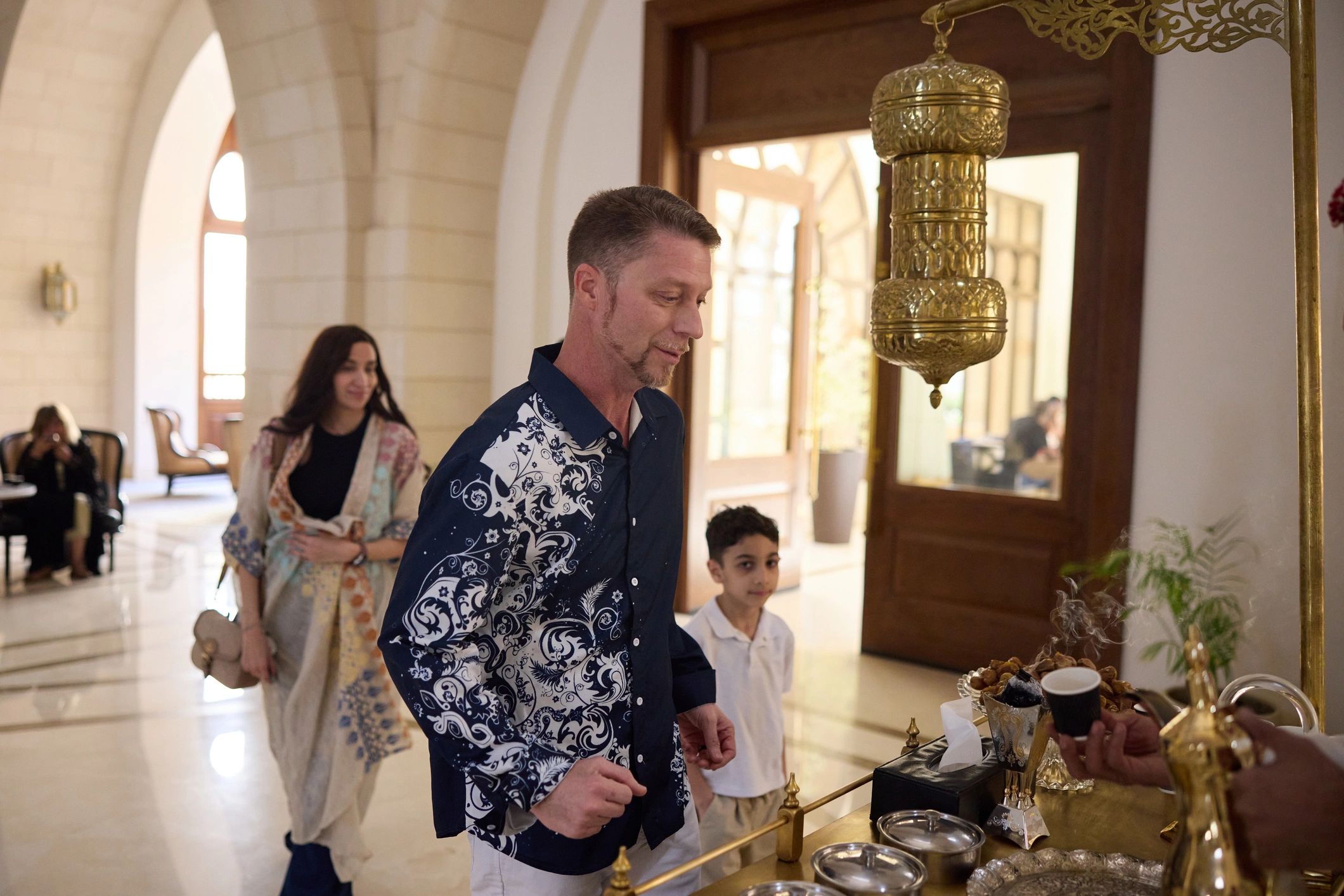 Guests receiving coffee service in a hospitality setting