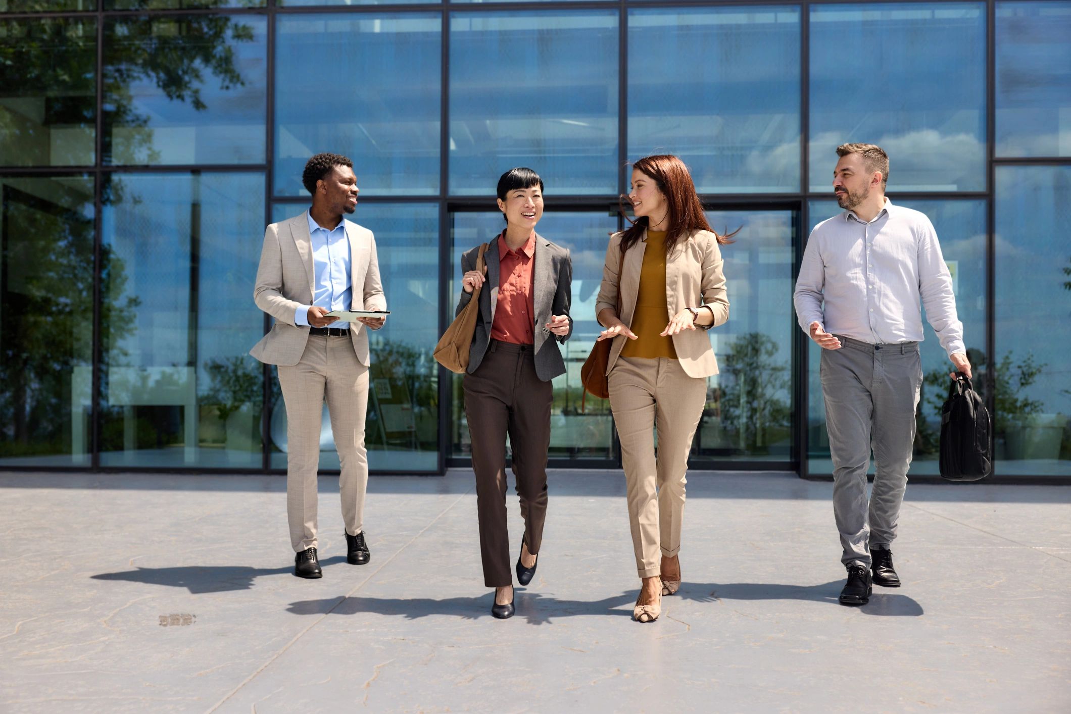 Multicultural entrepreneurs in conversation outside a workplace